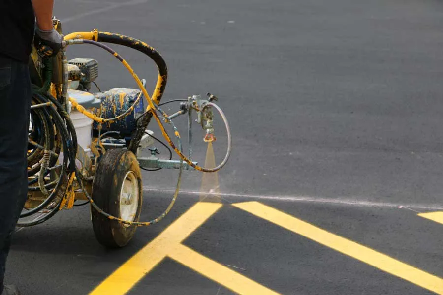 A Pro Stripe parking lot striping machine striping a parking lot